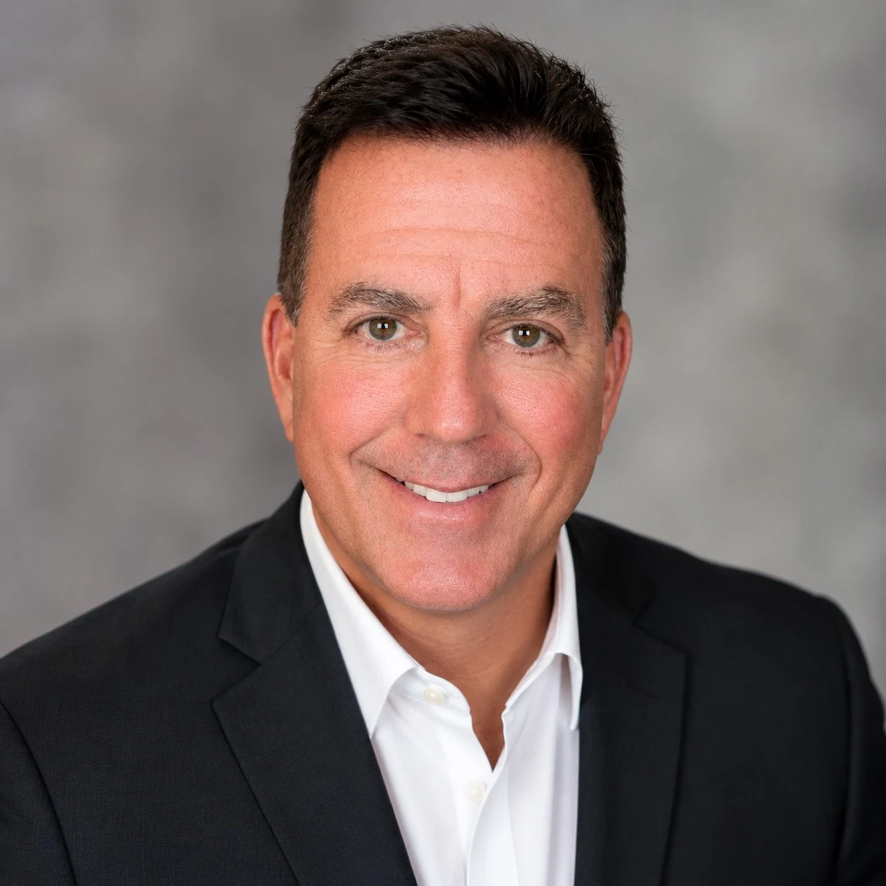 Professional headshot of Lee Rankin in a dark suit and white shirt